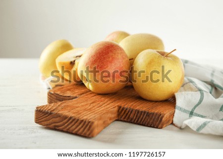 Ripe juicy apples on wooden board
