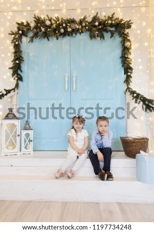 Small children are sitting. Christmas photo of children.