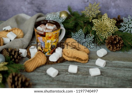 
Christmas cocoa drink with cinnamon and
Christmas cookies on wooden fox marshmallows, bumps in rustic style