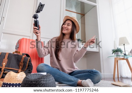 Asian young female blogger recording vlog video with mobile phone live streaming when travel.online influencer on social media viral concept Royalty-Free Stock Photo #1197775246