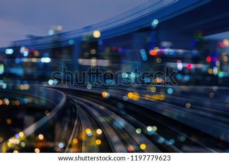 Train track motion curved over night blur light city building, abstract background
