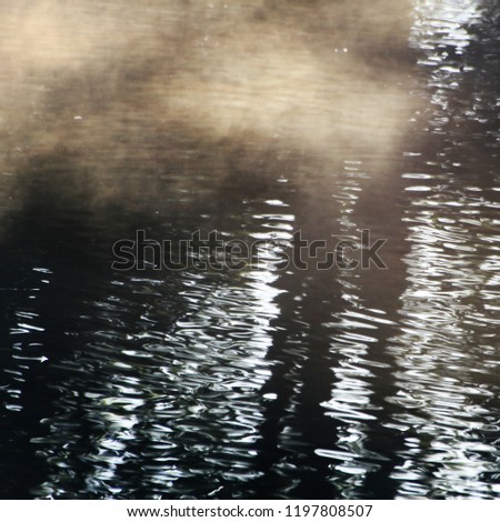 autumn picture with vapor over the river, with sunlight
