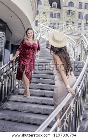New photo. Pleasant joyful woman standing on the stairs while having a photoshoot