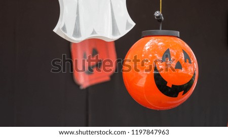 Halloween Pumpkin or jack o lantern hanging on a rope during yearly halloween celebration