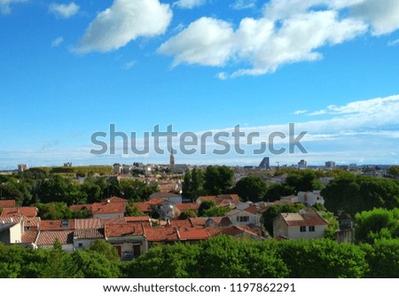The beautiful panorama of sunny day and blue sky with sunny reflection and colorful building and trees 
