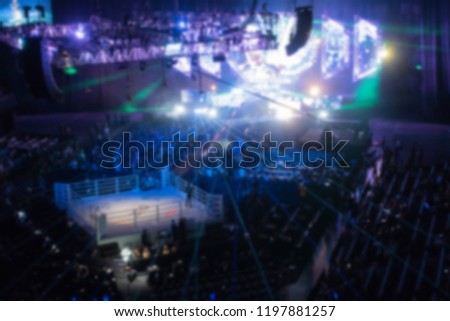 Blurry boxing stadium for background.