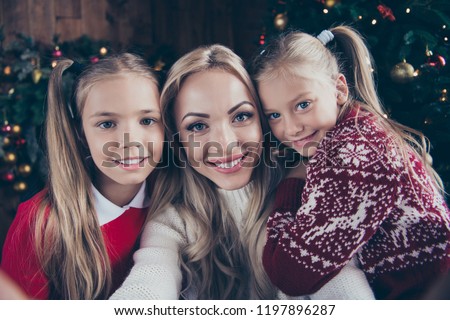 Noel winter childhood moments picture on memory. Cheerful positive glad funny mama take selfie with stylish cute nice face blonde small little pre-teen in cosy sweater chill comfort house with tree