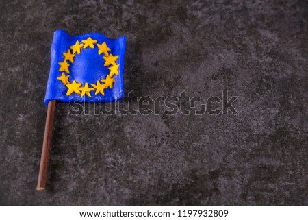 the flag of the European Union lies on a gray stone background