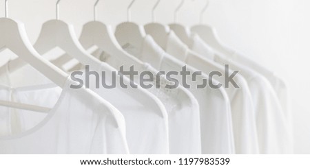 Ladies chiffon blouses hang on white wooden hangers. White lace blouses and jacket.  Fashion banner background