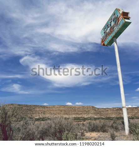 Old motel sign in the desert outside an abandoned ghost town

