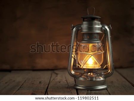 Oil Lamp at Night on a Wooden Surface Royalty-Free Stock Photo #119802511