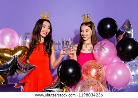 Friendship concept. Two elegant, graceful, charming, cheerful, fancy people with beverage cocktail in hands hold helium blow decoration stand isolated on shine violet background