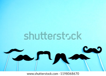 Symbol of annual event involving growing of moustache & beard during month in November to raise awareness of men health issues and prostate cancer. Background, close up, copy space, flat lay.