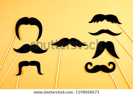 Symbol of annual event involving growing of moustache & beard during month in November to raise awareness of men health issues and prostate cancer. Background, close up, copy space, flat lay.