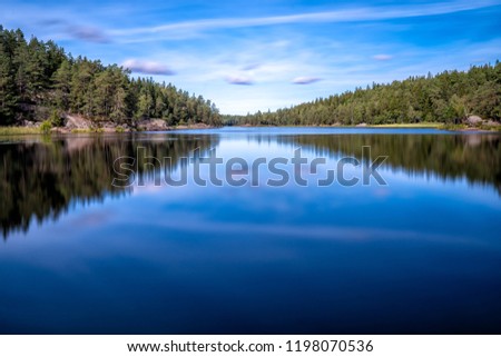 A Beautiful forest lake in Tyresta Nature Reserve, Sweden. Long Exposure.
 Royalty-Free Stock Photo #1198070536
