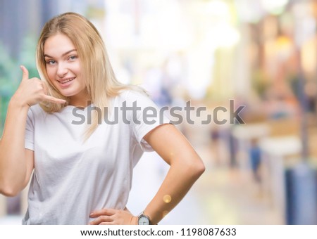 Young caucasian woman over isolated background smiling doing phone gesture with hand and fingers like talking on the telephone. Communicating concepts.