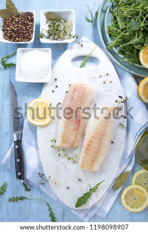 Fresh fish, raw cod fillets with addition of herbs and lemon 