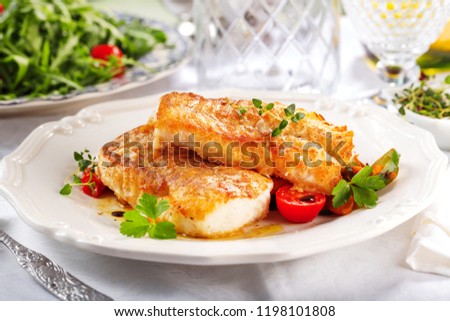 delicious fillets of grilled or oven baked pollock or coalfish served with a fresh salad Royalty-Free Stock Photo #1198101808