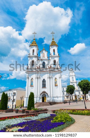 Beautiful white Church of Resurrection in Vitebsk, Belarus under dramatic cloudy sky on a sunny day