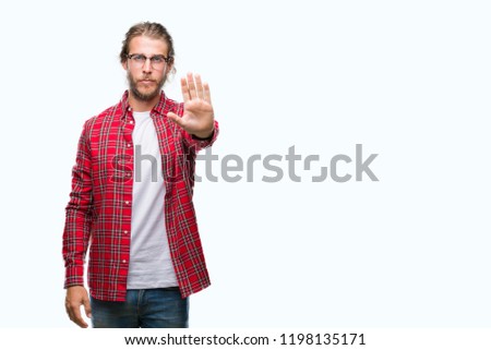 Young handsome man with long hair wearing glasses over isolated background doing stop sing with palm of the hand. Warning expression with negative and serious gesture on the face.