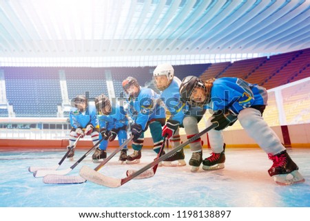 Children's hockey team line up on ice rink Royalty-Free Stock Photo #1198138897