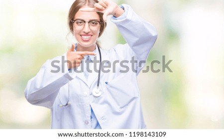 Beautiful young blonde doctor woman wearing medical uniform over isolated background smiling making frame with hands and fingers with happy face. Creativity and photography concept.