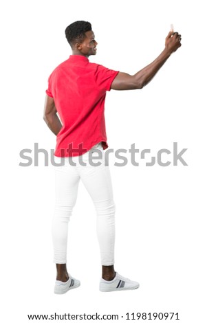 Full body of Young african american man taking a selfie with the mobile on white background