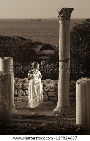 bride with a bouquet of flowers is on the ancient city