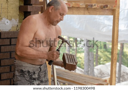 Bricklayer worker installing bricks on construction site.