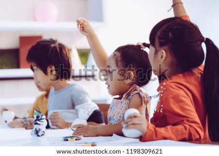 Asian girl and boys is painting on dolls in Art group