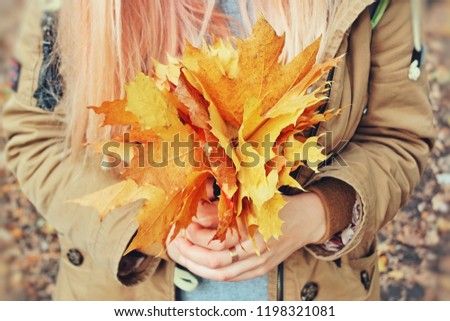 autumn bouquet of leaves in hand close up 