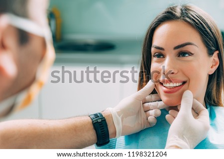 Young smiling woman with beautifiul teeth, having a dental inspection Royalty-Free Stock Photo #1198321204