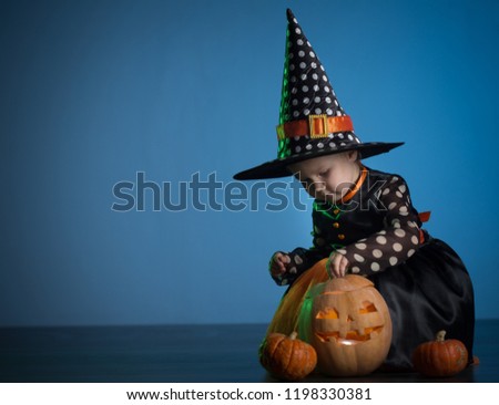 Baby in Halloween costumes, girl two years old