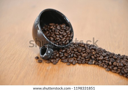 coffee beans roasted dark out of cup 