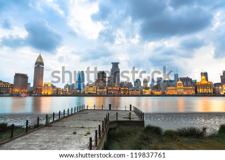 beautiful shanghai bund with old pier at sunset