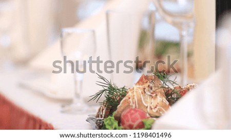 blurred image of a bottle of wine and appetizer on the table
