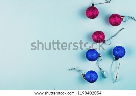 Lot of scattered christmas balls red and blue colors with silver thread on blue background with copy space for your text