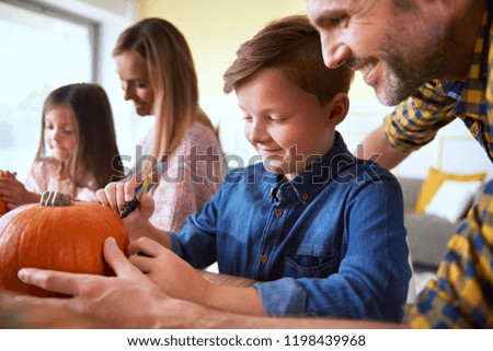 Family preparing decorations for Halloween time