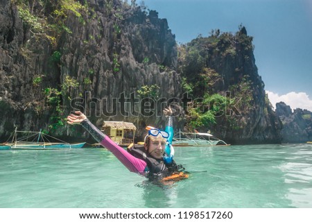 Female snorkeling underwater - Adventure travel lifestyle enjoying happy fun moment - Trip around Philippines wonders