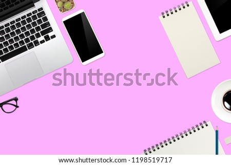 flat lay workspace table with laptop computer, office supplies, coffee cup, cell phone, tablet and coffee cup on pink background
