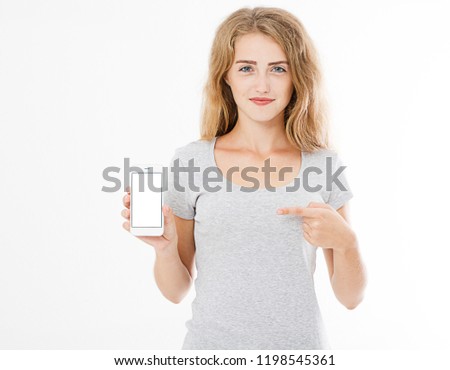 Portrait of smiling attractive, pretty, woman, girl in tshirt hold cellphone, blank screen mobilephone pointing isolated on white background, copy space.