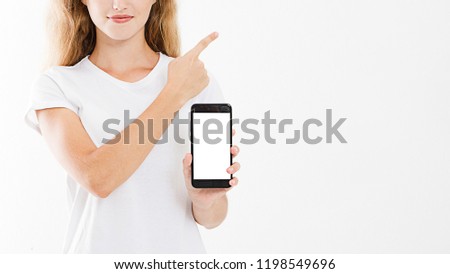smiling attractive girl,woman hold blank screen cellphone, pointing finger isolated on white background, hand holding black phone, copy space