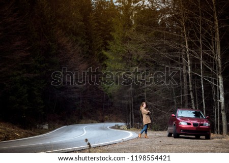 autotrip - girl and mountain road at the Romanian Carpathians, Romania
 Royalty-Free Stock Photo #1198554421