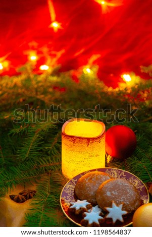 christmas decoration with candles, christmas tree balls and christmas biscuits