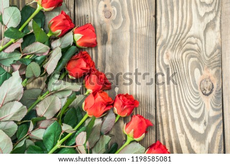 Happy Mother's Day, Women's Day, Valentine's Day or Birthday Flat Lay Background. Red roses on a wooden background.