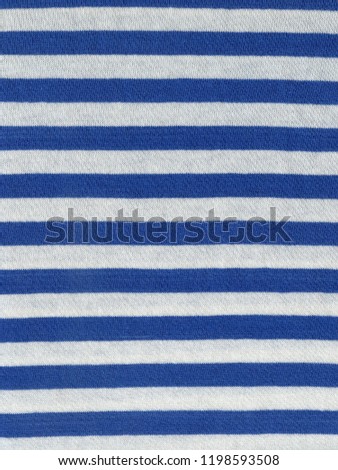 Scan of striped sailor`s vest fabric texture with white and blue stripes pattern