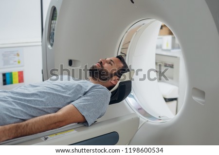 Patient lying on the TC scanner bed waiting to be scanned. Royalty-Free Stock Photo #1198600534