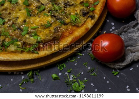 Pizza with mushrooms and cheese on a dark background