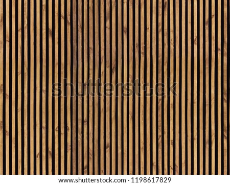 Seamless pattern of modern wall paneling with vertical wooden slats for background. Raw material of natural brown wood lath. Royalty-Free Stock Photo #1198617829
