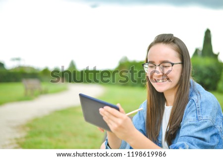 Student girl in glassses outdoor in jeans casual look